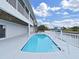 Outdoor pool in backyard by water, ideal for enjoying a swim or relaxing in the sun with a view of the channel at 7438 Gulf Way, Hudson, FL 34667