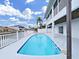 Backyard featuring a pool and a partial view of the canal, perfect for enjoying waterfront living and relaxation at 7438 Gulf Way, Hudson, FL 34667