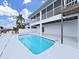 Private pool with ladder and backyard with a glimpse of the canal, great for summer enjoyment and outdoor living at 7438 Gulf Way, Hudson, FL 34667