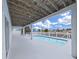 Inviting pool area featuring a covered patio with a wooden ceiling, columns, and a pristine swimming pool at 7438 Gulf Way, Hudson, FL 34667