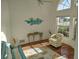 Living room with hardwood floors and large windows at 1 Long Meadow Ln, Rotonda West, FL 33947