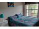 Bright bedroom with a queen-size bed and large window at 1 Long Meadow Ln, Rotonda West, FL 33947