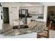 Well-equipped kitchen featuring granite counters and stainless steel appliances at 1 Long Meadow Ln, Rotonda West, FL 33947