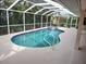 Large kidney-shaped pool with a spa and screened enclosure at 1 Long Meadow Ln, Rotonda West, FL 33947