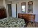Bedroom with double bed and wooden dresser at 1 Long Meadow Ln, Rotonda West, FL 33947