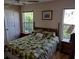 Bedroom with double bed, nightstands, and large windows at 1 Long Meadow Ln, Rotonda West, FL 33947