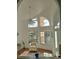 Spacious living room with vaulted ceilings and ample natural light at 1 Long Meadow Ln, Rotonda West, FL 33947
