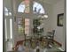 Bright dining room with glass table and seating for six at 1 Long Meadow Ln, Rotonda West, FL 33947