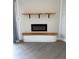 Living room features modern electric fireplace with wood mantle and shelving accents at 12550 Capri N Cir, Treasure Island, FL 33706