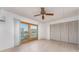 Bedroom with hardwood floors, sliding glass doors, and large closet at 12550 Capri N Cir, Treasure Island, FL 33706
