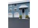 Three-unit building with attached garages and shared staircase at 12550 Capri N Cir, Treasure Island, FL 33706