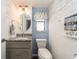 Small bathroom with light blue walls and shiplap accents at 12550 Capri N Cir, Treasure Island, FL 33706