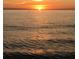 Beautiful sunset over the ocean with calm waters at 12550 Capri N Cir, Treasure Island, FL 33706
