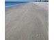 Empty beach with tire tracks and footprints in the sand at 12550 Capri N Cir, Treasure Island, FL 33706
