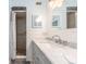 Clean bathroom with marble countertop and shower at 12550 Capri N Cir, Treasure Island, FL 33706