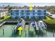 Condo building exterior showcasing water access and boat slips at 12550 Capri N Cir, Treasure Island, FL 33706