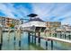 Pontoon boat on a lift in a marina setting at 12550 Capri N Cir, Treasure Island, FL 33706