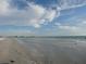 Scenic beach view with calm ocean waves and blue skies at 12550 Capri N Cir, Treasure Island, FL 33706