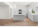 Modern kitchen featuring white shaker cabinets, quartz countertops, and stainless steel appliances at 1819 Lakeport St, North Port, FL 34288