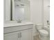 Modern bathroom with white vanity, toilet, and bathtub at 14074 Ginnie Springs Way, Parrish, FL 34219