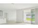 Open living room with sliding glass doors and kitchen view at 14074 Ginnie Springs Way, Parrish, FL 34219