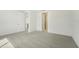 Well-lit bedroom with carpet flooring, and doors to bathroom and hallway at 14074 Ginnie Springs Way, Parrish, FL 34219