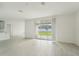 Spacious living room with sliding glass doors and view of backyard at 14074 Ginnie Springs Way, Parrish, FL 34219