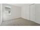 Spacious bedroom with carpet, window, and double doors at 14074 Ginnie Springs Way, Parrish, FL 34219