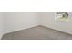 Well-lit bedroom featuring grey carpet and window at 14074 Ginnie Springs Way, Parrish, FL 34219