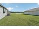 Grass lawn, pond view, and partial view of neighboring homes at 14074 Ginnie Springs Way, Parrish, FL 34219