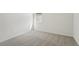 Simple bedroom with carpeted floors and a window with blinds at 14074 Ginnie Springs Way, Parrish, FL 34219