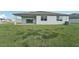 Home features a covered patio, spacious backyard, and AC unit at 14074 Ginnie Springs Way, Parrish, FL 34219