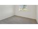 Bright bedroom with window and grey carpet at 14074 Ginnie Springs Way, Parrish, FL 34219