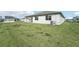 Large backyard with grassy area and partial view of neighboring homes at 14074 Ginnie Springs Way, Parrish, FL 34219