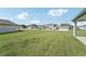 Large grassy front yard with a view of the neighborhood at 14074 Ginnie Springs Way, Parrish, FL 34219