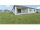 Rear view of house showing patio and yard at 14074 Ginnie Springs Way, Parrish, FL 34219