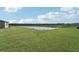 Spacious backyard with pond view and lush green grass at 14074 Ginnie Springs Way, Parrish, FL 34219