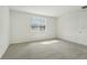 Spacious bedroom with window and grey carpet at 14074 Ginnie Springs Way, Parrish, FL 34219