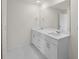 Bathroom boasts a double vanity with white cabinets and hexagon tile floor at 5255 Farmington Ave, North Port, FL 34288