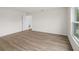 Light and airy bedroom with wood-look flooring and access to another room at 5255 Farmington Ave, North Port, FL 34288