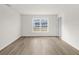 Well-lit bedroom with wood-look floors and a window offering backyard views at 5255 Farmington Ave, North Port, FL 34288