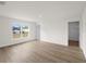 Bright bedroom featuring wood-look flooring and a large window at 5255 Farmington Ave, North Port, FL 34288