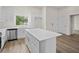 Bright kitchen with white cabinets, center island and stainless steel appliances at 5255 Farmington Ave, North Port, FL 34288