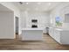 Modern kitchen featuring white cabinetry, a large island, and stainless steel appliances at 5255 Farmington Ave, North Port, FL 34288