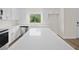 Modern kitchen with white cabinets, stainless steel appliances, and a large kitchen island at 5255 Farmington Ave, North Port, FL 34288