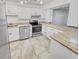 Modern kitchen featuring granite countertops and stainless steel appliances at 1200 Tarpon Woods Blvd # S2, Palm Harbor, FL 34685
