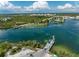 Aerial view of a car ferry crossing a scenic waterway surrounded by lush greenery and waterfront homes at 7442 Palm Island Dr # 3624, Placida, FL 33946