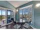 Charming breakfast nook with bay window and table seating, flowing onto a screened balcony with ocean view at 7442 Palm Island Dr # 3624, Placida, FL 33946