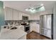 Bright kitchen with stainless steel appliances, white cabinets, and marble countertops at 7442 Palm Island Dr # 3624, Placida, FL 33946
