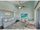 Cozy living room with light blue walls, featuring a comfortable sofa and beach-themed artwork at 7442 Palm Island Dr # 3624, Placida, FL 33946